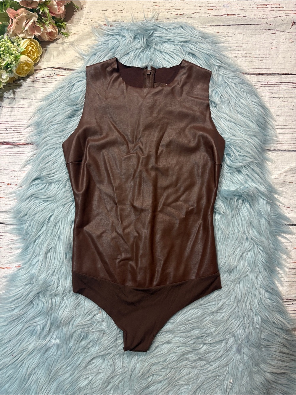Skims Faux Leather Crew Neck Thong Bodysuit in Sienna